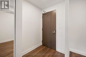 Markham (Grandview) condo for rent - A brown door in a white room with wooden flooring.