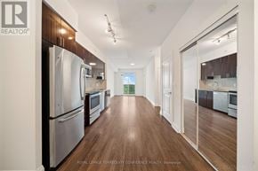 Markham (Grandview) condo for rent - A kitchen with wooden floors and stainless steel appliances.