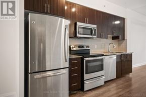 Markham (Grandview) condo for rent - A kitchen with a stainless steel refrigerator and microwave.