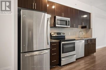 Markham (Grandview) condo for rent - A kitchen with a stainless steel refrigerator and microwave.