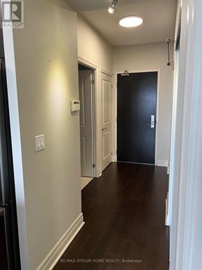Markham (Unionville) condo for rent - A hallway with a black door and white walls.