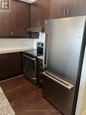 Markham (Unionville) condo for rent - A kitchen with a stainless steel refrigerator and a stove.