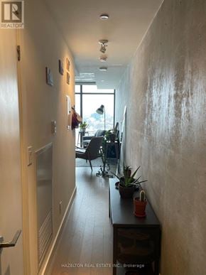 Toronto (Waterfront Communities) condo for rent - A hallway with a table and chairs in the background.