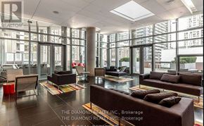 Toronto (Waterfront Communities) condo for rent - A large, modern living room with a glass wall and a variety of seating options.