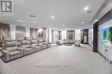 Toronto (Islington-City Centre West) condo for rent - A spacious living room with a row of beige sofas and a television on the wall.