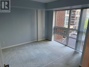 Toronto (Islington-City Centre West) condo for rent - A room with a large window and a view of a street and buildings outside.