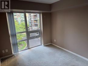 Toronto (Islington-City Centre West) condo for rent - A room with a large window and a view of a building outside.