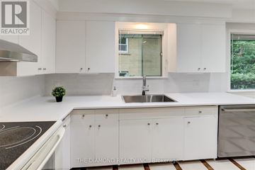 Toronto (Kingsway South) apartment for rent - A modern kitchen with white cabinets and a diamond logo on the counter.