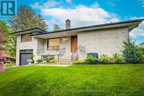 Toronto (Kingsway South) apartment for rent - A house with a well-maintained lawn and a clear sky in the background.