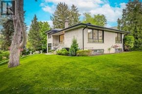 Toronto (Kingsway South) apartment for rent - A house with a well-maintained lawn in front of it.