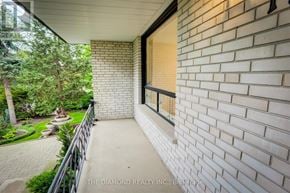Toronto (Kingsway South) apartment for rent - A balcony with a black railing and a brick wall.