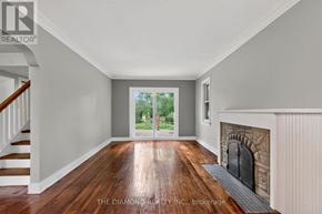 Toronto (Islington-City Centre West) apartment for rent - A room with a fireplace and a view of trees through the door.
