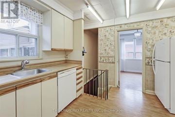 Toronto (Edenbridge-Humber Valley) apartment for rent - A kitchen with wooden cabinets and a white fridge.