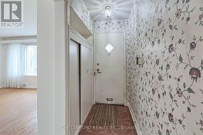 Toronto (Edenbridge-Humber Valley) apartment for rent - A hallway with floral wallpaper and a wooden floor.