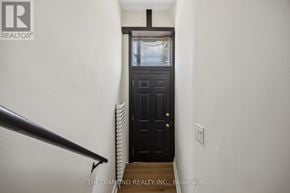 Toronto (Briar Hill-Belgravia) apartment for rent - A black door is at the end of a hallway.