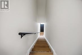 Toronto (Briar Hill-Belgravia) apartment for rent - A long hallway with a bench and light at the end.