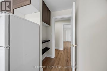 Toronto (Briar Hill-Belgravia) apartment for rent - A white refrigerator is in a kitchen with a white door.