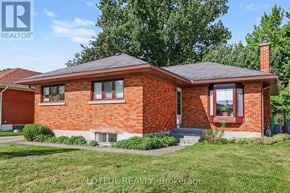 Ottawa apartment for rent - A red brick house with a black roof and a chimney.