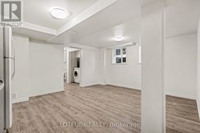 Ottawa apartment for rent - A spacious room with a washer and dryer in it.