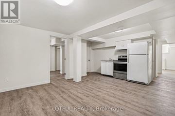 Ottawa apartment for rent - A spacious kitchen with white appliances and wooden flooring.