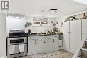 Windsor apartment for rent - A kitchen with white cabinets and a black stove top.