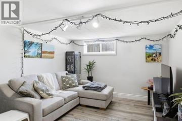 Windsor apartment for rent - A living room with a grey couch and a small table.
