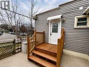 London apartment for rent - A small house with a white door and a wooden porch.