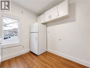 London apartment for rent - A white refrigerator in a room with wooden floors and white walls.