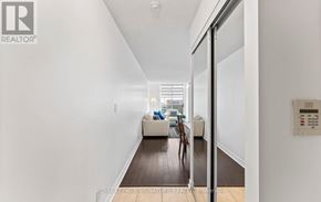 Toronto (Mount Pleasant West) condo for rent - A hallway with a Royal LePage sign on the wall.