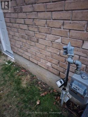 Clarington (Bowmanville) apartment for rent - A grey electrical box is attached to a brick wall.
