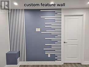 Clarington (Bowmanville) apartment for rent - A white door is next to a wall with a blue and white striped wallpaper.