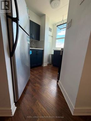 Ajax (Central West) condo for rent - A kitchen with a refrigerator, cabinets, and a window.
