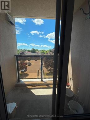 Ajax (Central West) condo for rent - A balcony with a view of the sky and a parking lot.