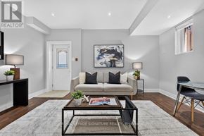 Toronto (Clairlea-Birchmount) apartment for rent - A living room with a couch, coffee table, and a painting on the wall.