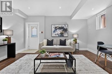 Toronto (Clairlea-Birchmount) apartment for rent - A living room with a couch, coffee table, and a painting on the wall.