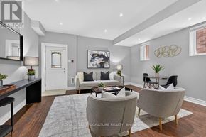 Toronto (Clairlea-Birchmount) apartment for rent - A well-lit living room with a grey sofa and a coffee table.