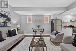 Toronto (Clairlea-Birchmount) apartment for rent - A living room with a grey couch, a coffee table, and a painting on the wall.