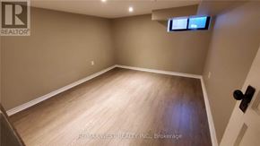 Toronto (Dovercourt-Wallace Emerson-Junction) apartment for rent - A room with a wooden floor and a small window.