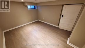 Toronto (Dovercourt-Wallace Emerson-Junction) apartment for rent - A room with a wooden floor and a white door.