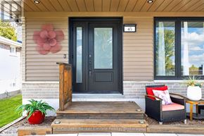 Halton Hills (Georgetown) apartment for rent - A house with a black door and a flower on the wall.