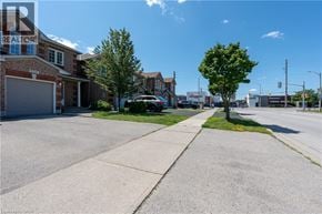 Burlington townhouse for rent - A street view with a house number 4008 and a tree.