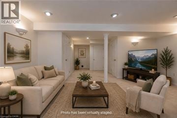 Burlington townhouse for rent - A living room with a couch, chair, and a painting on the wall.