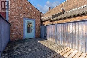 Hamilton apartment for rent - A blue door is on the left side of a wooden deck.