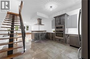 Hamilton apartment for rent - A modern kitchen with a wooden staircase on the left side.