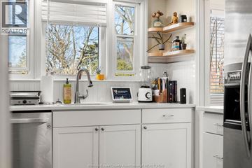 Windsor apartment for rent - A kitchen with white cabinets and a window above the sink.