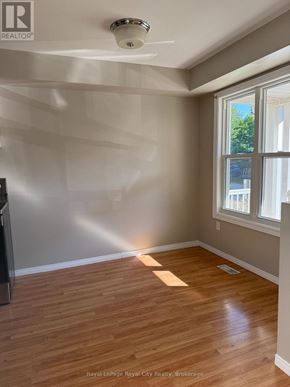 Guelph (Downtown) townhouse for rent - A room with wooden flooring and a ceiling fan.