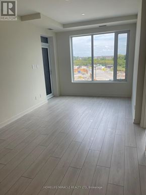 Milton (Co Coates) condo for rent - A room with a large window and wooden flooring.