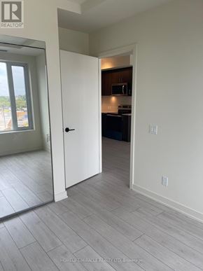 Milton (Co Coates) condo for rent - A real estate photo of a kitchen area with a door open to a living room.