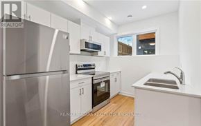 Welland (N. Welland) townhouse for rent - A modern kitchen with white cabinets and stainless steel appliances.