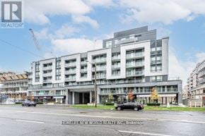 Toronto (Bayview Village) condo for rent - A large building with a sign that says "HOMELIFE NEW WORLD REALTY INC. Brokerage" in front of it.